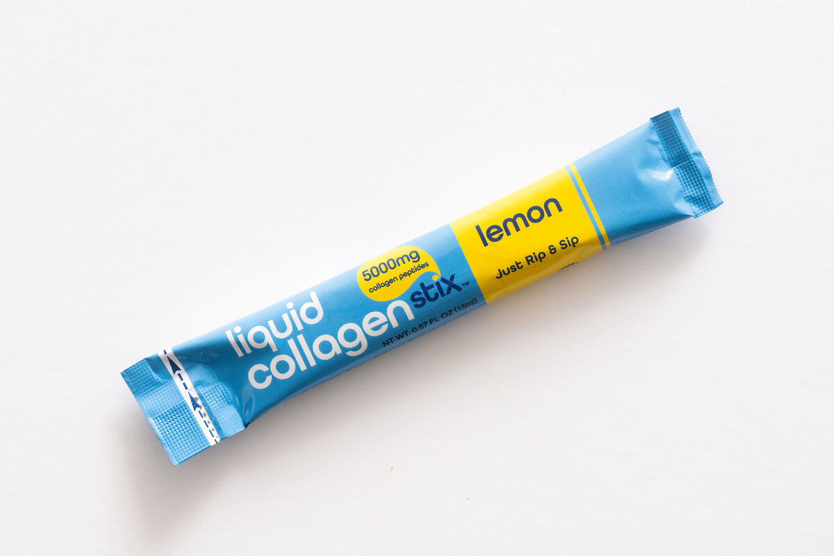 Blue and yellow package of liquid collagen stick on a white background. Drinkable lemon liquid collagen stick pack