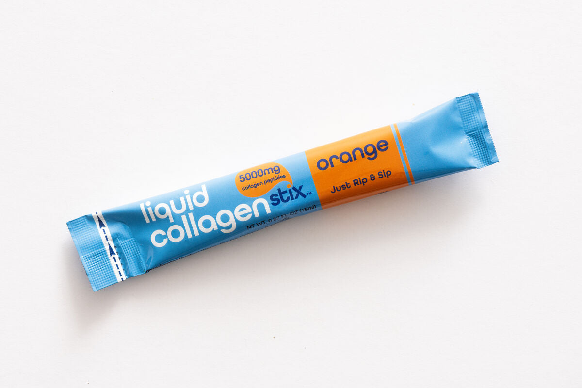 Liquid collagen stick pack with blue and orange packaging on a white background. Orange flavored stick pack. 
